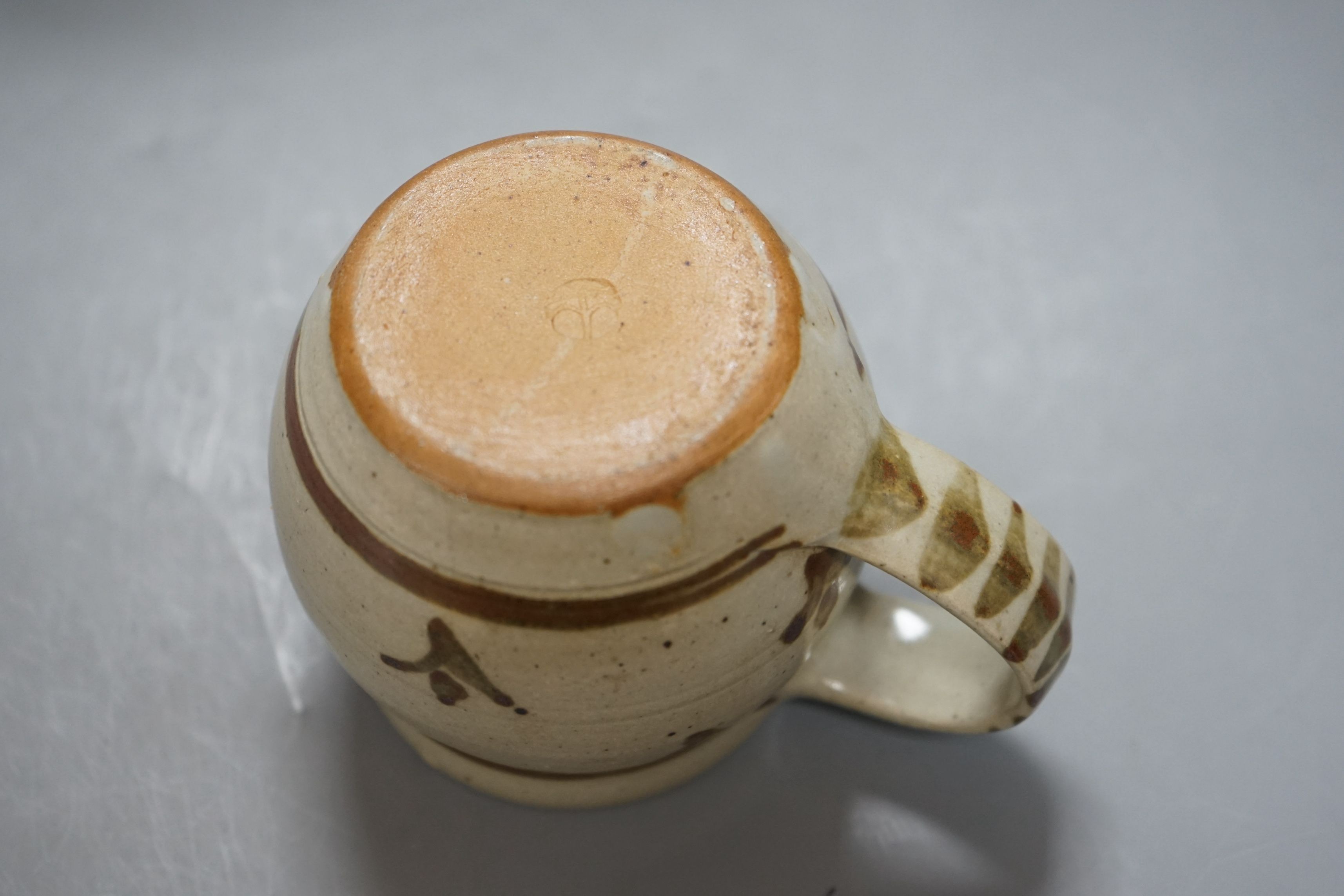 An Accolay style blue glazed stripe vase, together with a Wenford Bridge stoneware mug, both with impressed marks, tallest 19cm, (2)